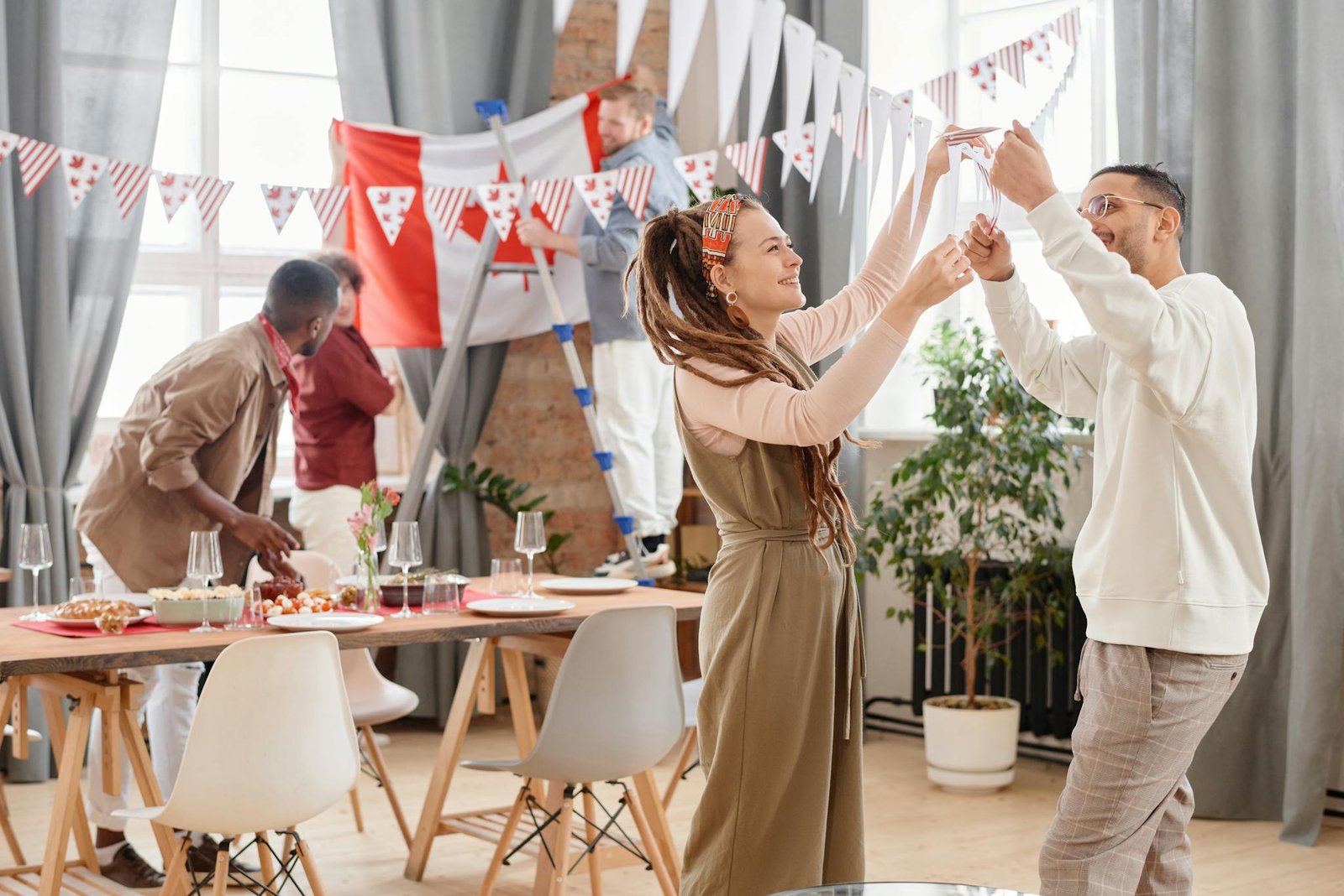 Young adults enjoying a festive indoor party with decorations and celebration vibes.